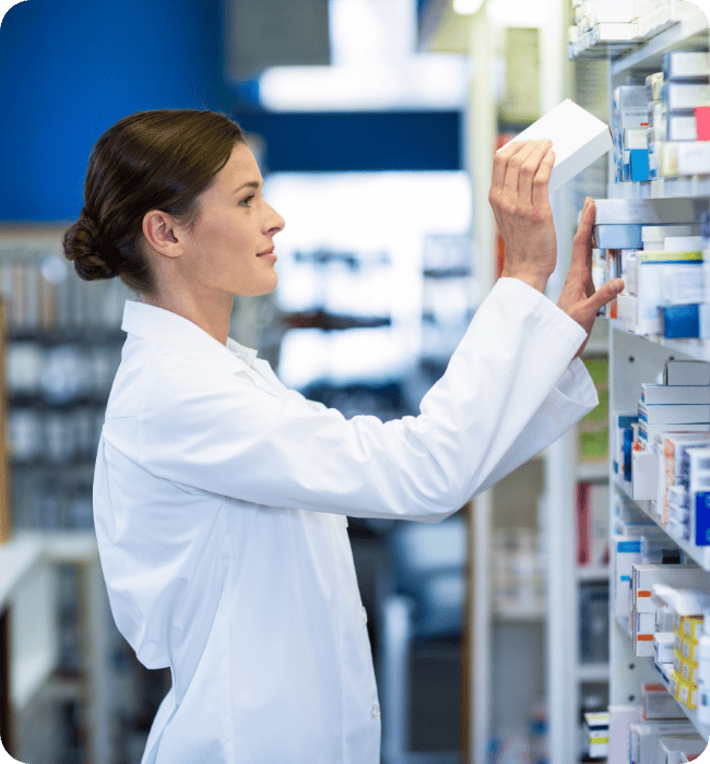 A pharmacist stacking shelves.